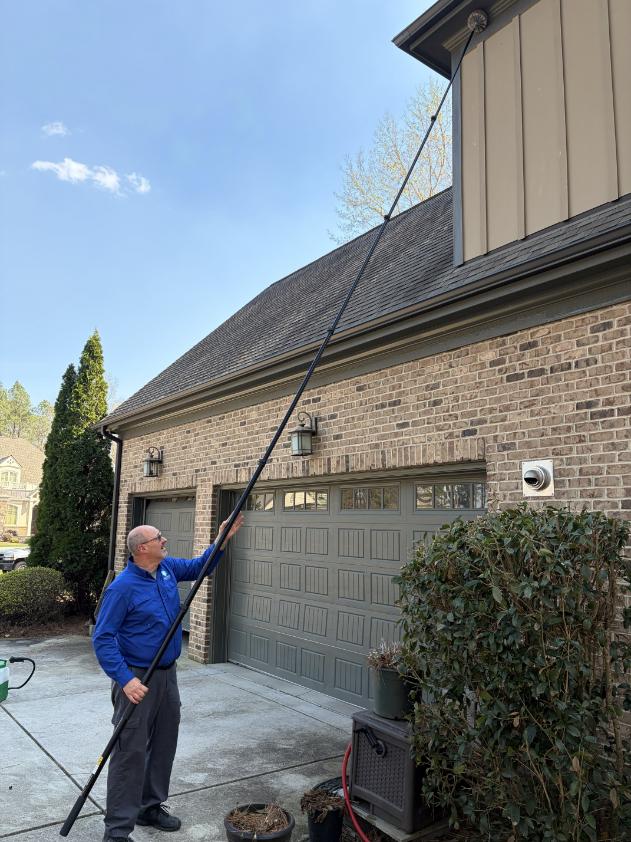 why-homeowners-choose-ready-pest image Ready Pest Solutions technician treating the exterior of a home